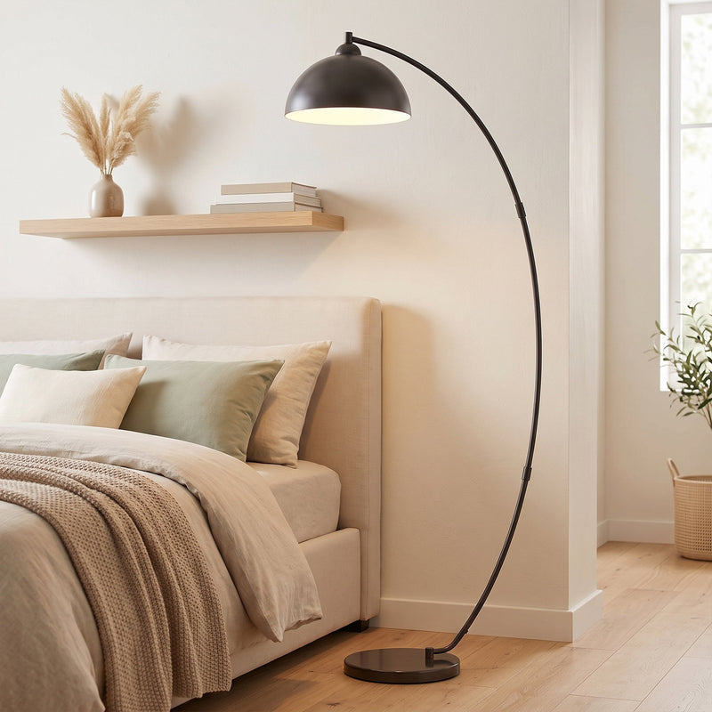 Arc floor lamp by a bed under a wall shelf