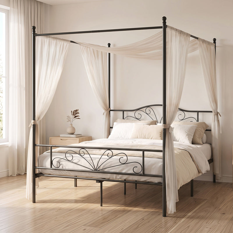 Black canopy bed frame styled in a bedroom with cream sheer curtains
