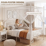 Woman relaxing on the white bed frame with the four-poster net tied back