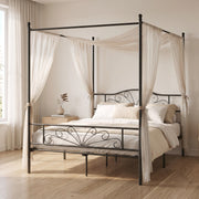 Black canopy bed frame styled with sheer drapes in a bright bedroom