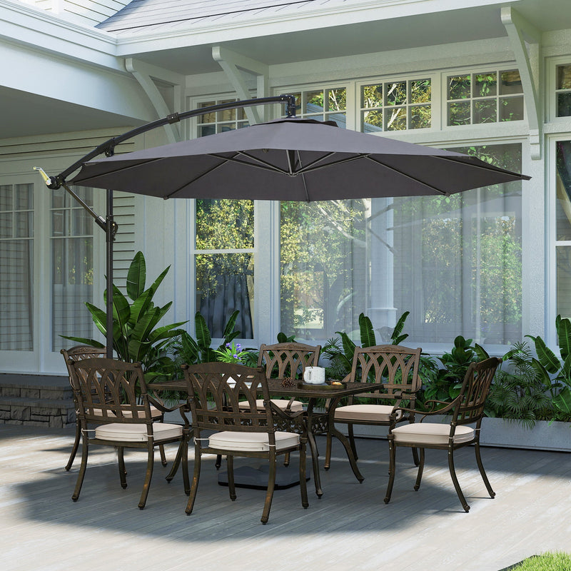 Grey cantilever parasol over a metal garden dining table and chairs on a patio
