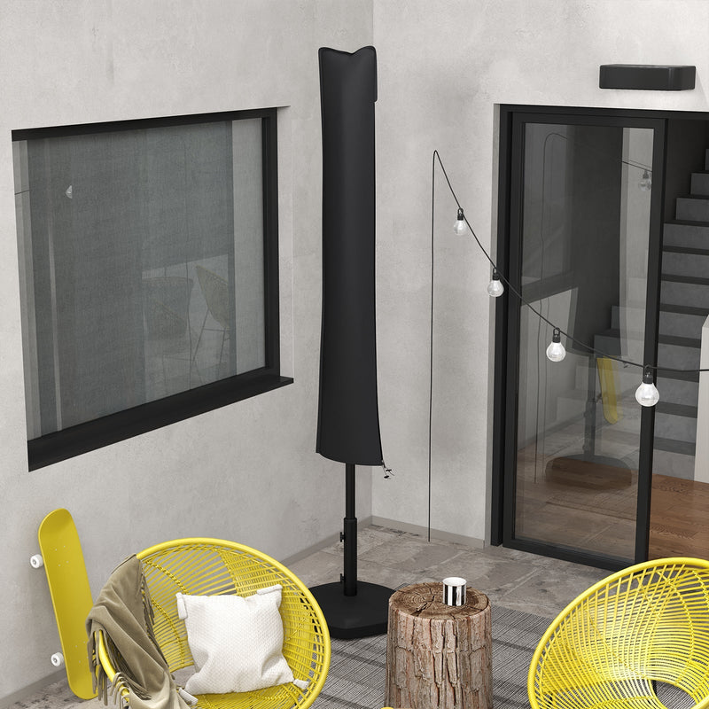 Cover on a closed parasol in an evening patio setting with yellow rattan chairs