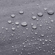 Water droplets beading on the surface of the grey non-woven fabric cover