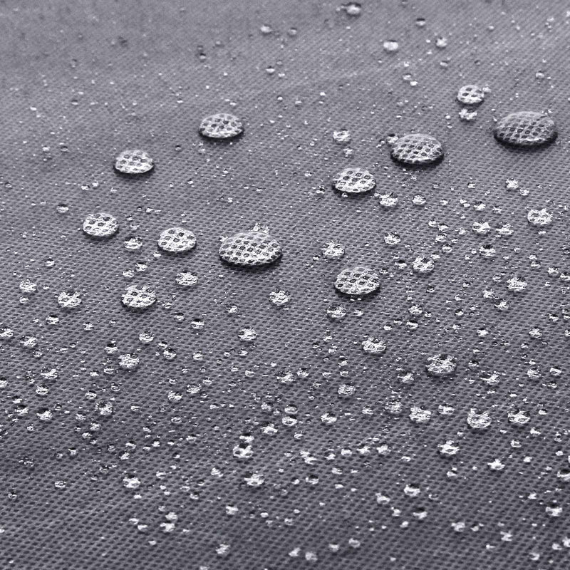 Water droplets beading on the surface of the grey non-woven fabric cover