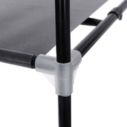 Close-up of a fabric shelf clipped to the black steel tube at a translucent plastic corner connector