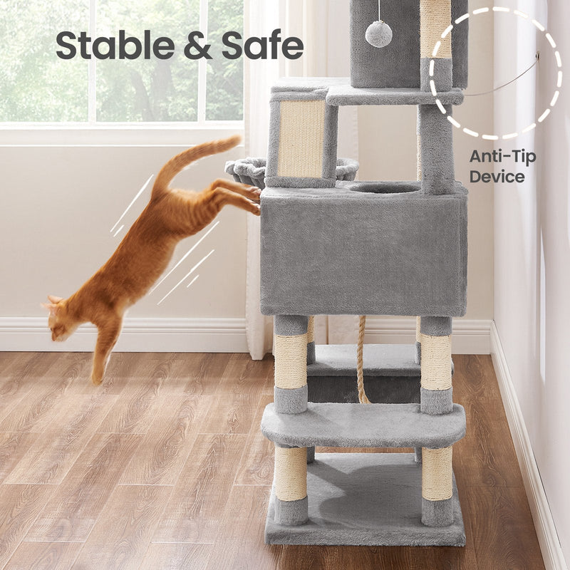 Anti-tip device fixed to the wall as a ginger cat leaps onto the light grey cat tree