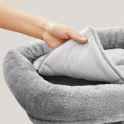 Hand lifting the removable plush cushion out of the cat tree top perch