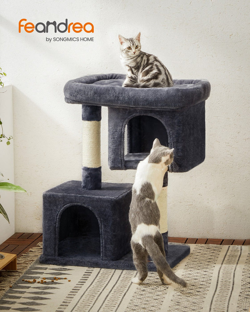 Lifestyle photo of a cat climbing the Feandrea cat tree tower in a living room