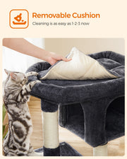 Hand removing the top cushion of the cat tree to show it is removable for cleaning