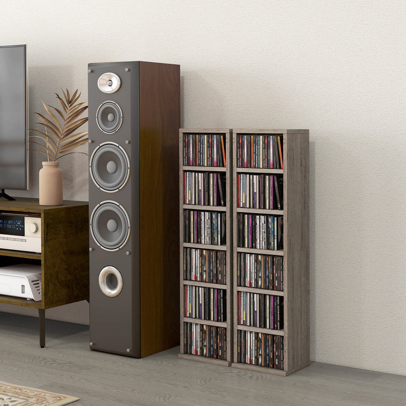 Two filled CD towers next to a floor-standing speaker