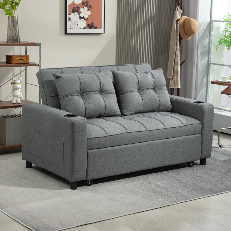 Charcoal grey sofa bed in a bright living room with a bookshelf