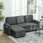 Charcoal grey L-shaped sofa bed styled in a living room with a plant and floor lamp