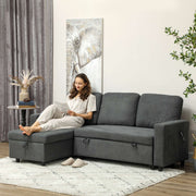 Charcoal grey sofa bed in a styled living room with a woman reading on the chaise