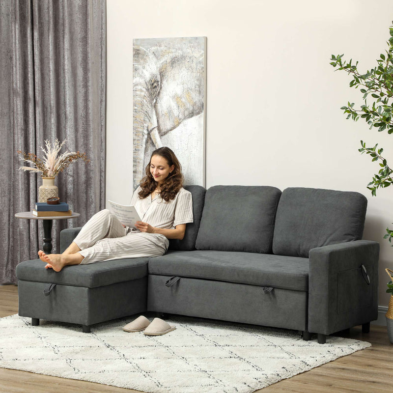Charcoal grey sofa bed in a styled living room with a woman reading on the chaise