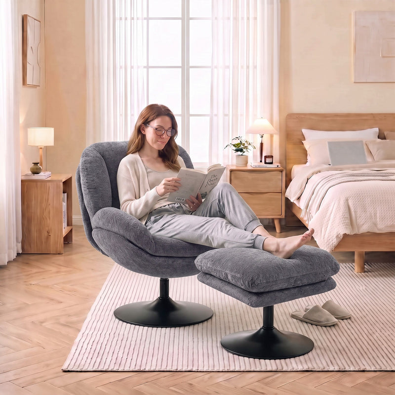 Woman with glasses reading in the dark grey lazy chair in a bright bedroom
