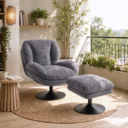 Dark grey lazy chair and ottoman by a balcony window with plants and a wooden side table