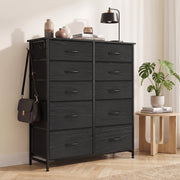 Black fabric chest of drawers with a bag on the side hook in a bedroom