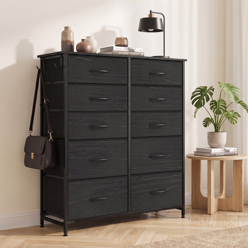 Black fabric chest of drawers with a bag on the side hook in a bedroom