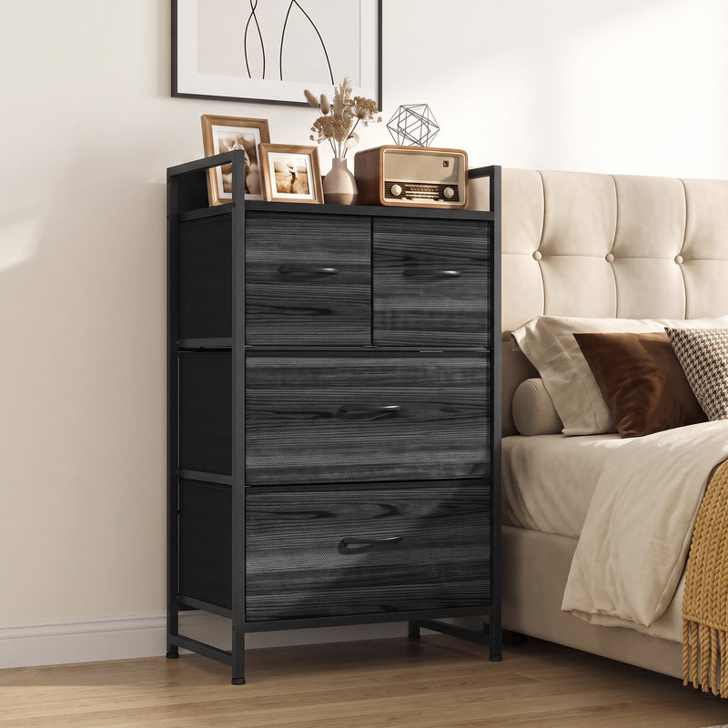 Chest of drawers next to an upholstered bed with framed photos and a radio on top