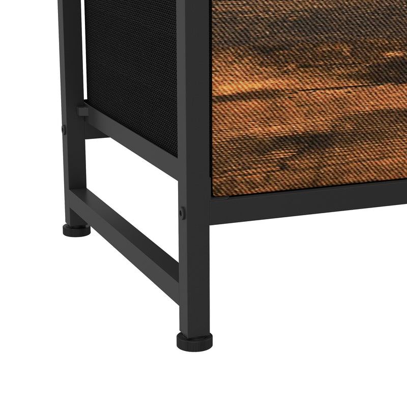Close-up of a black adjustable foot and the base of the chest of drawers