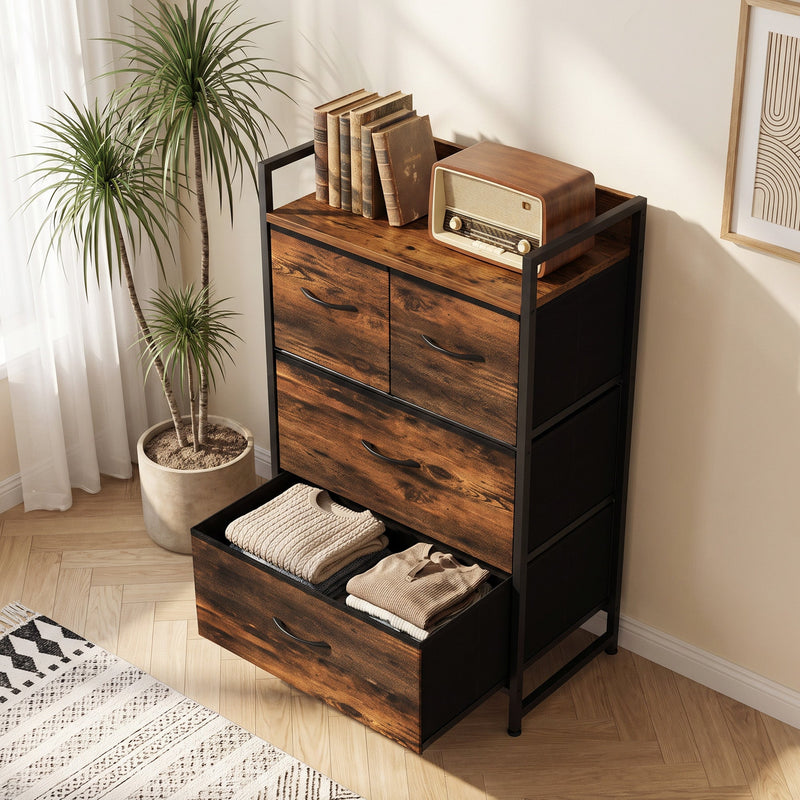 Chest of drawers beside a plant with books on top and the bottom drawer open