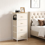Chest of drawers next to an upholstered bed with headphones hanging on a hook, shown in beige