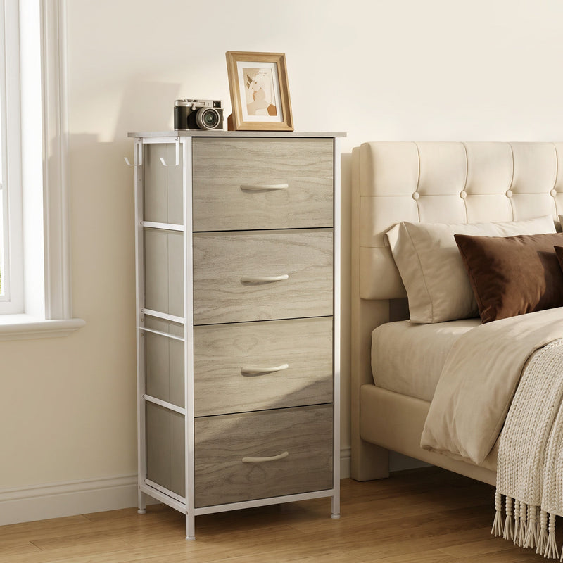Chest of drawers beside a bed with a camera and photo frame on top, shown in oak