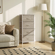 Chest of drawers next to an armchair and floor lamp in a living room, shown in oak
