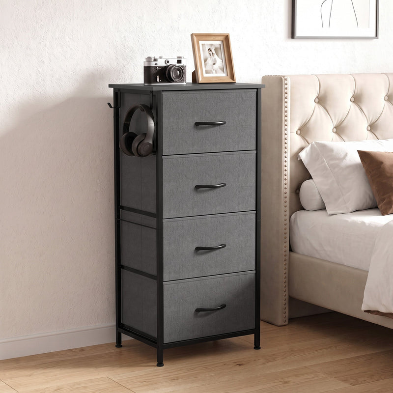 Grey fabric chest of drawers beside a bed in a bedroom