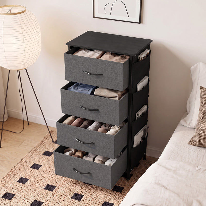 Grey fabric chest of drawers with drawers open and clothes inside in a bedroom