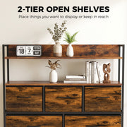 Two open shelves above the drawers displaying plants, books, a flip clock and ornaments