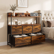 Rustic brown chest of drawers in a bedroom with shoes in the open bottom drawer and books on the shelves