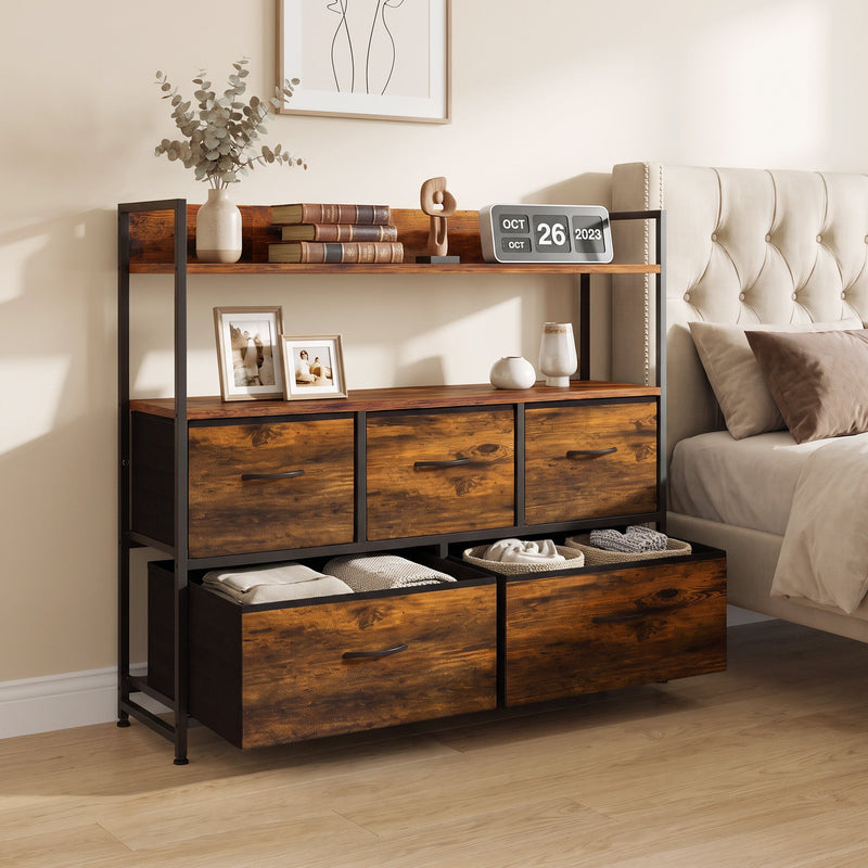 Rustic brown chest of drawers in a bedroom with shoes in the open bottom drawer and books on the shelves
