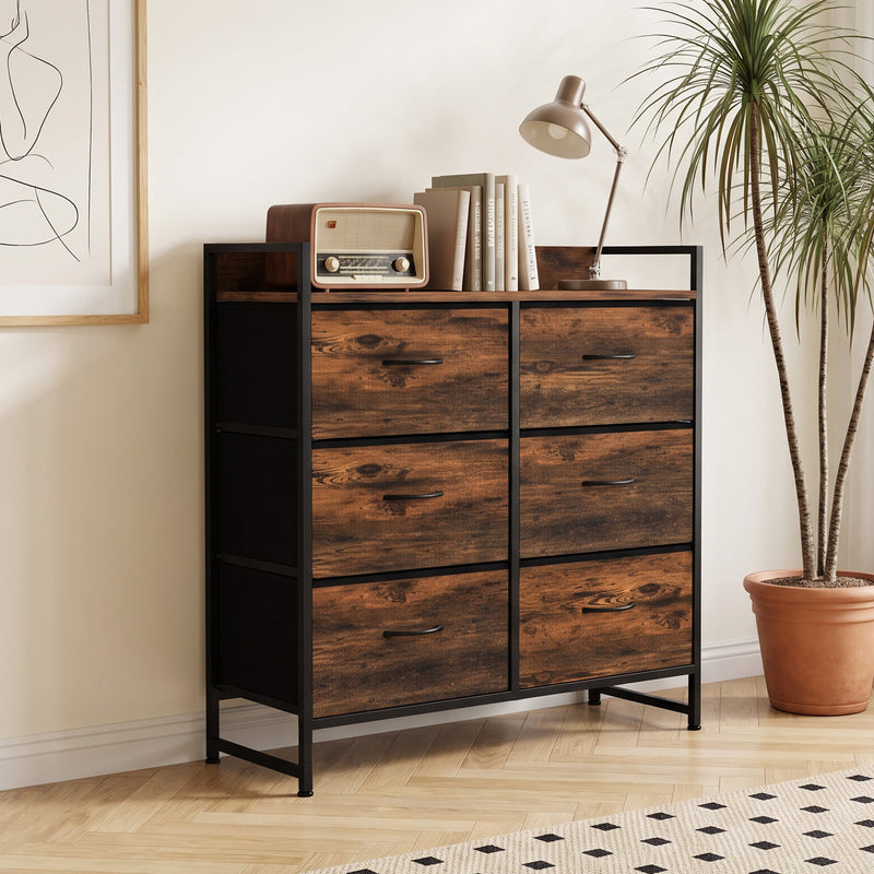 Six-drawer chest of drawers in a bedroom corner with lamp, radio and books on top