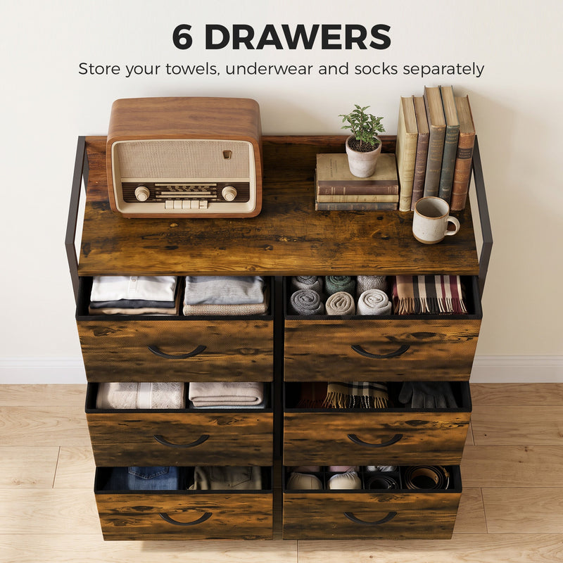 Chest of drawers with six open drawers showing folded towels, underwear and socks