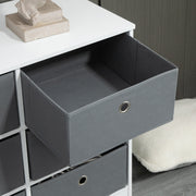 Close-up of an open grey fabric drawer on the white chest