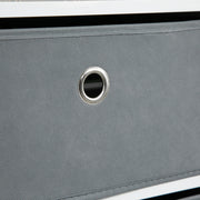 Close-up of the grey fabric drawer front with its metal eyelet pull
