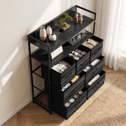 Black chest of drawers seen from above at an angle with socks and clothes stored in the open drawers