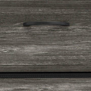 Close-up of the grey wood-effect drawer front and recessed handle