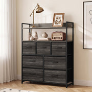Grey 7-drawer chest of drawers in a bedroom with a lamp, framed photo and radio on the shelves