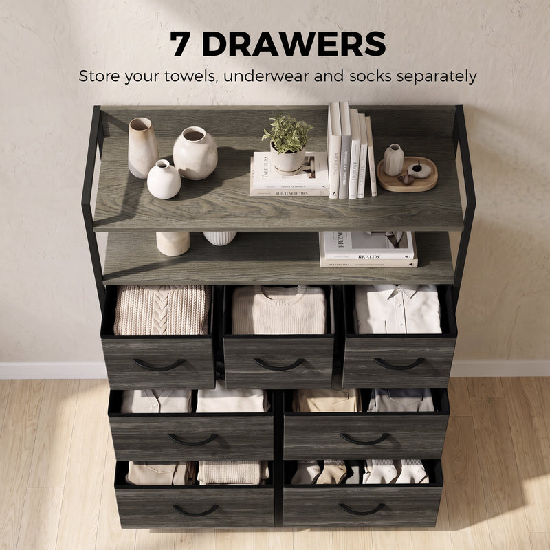 Grey chest of drawers with towels, underwear and socks neatly stored in the seven fabric drawers