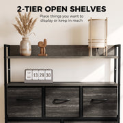 Two open shelves on the grey chest of drawers displaying a vase, a lamp and a flip clock