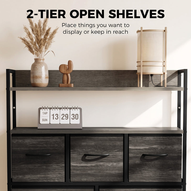 Two open shelves on the grey chest of drawers displaying a vase, a lamp and a flip clock