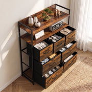 Rustic brown chest of drawers seen from above at an angle with socks and clothes stored in the open drawers
