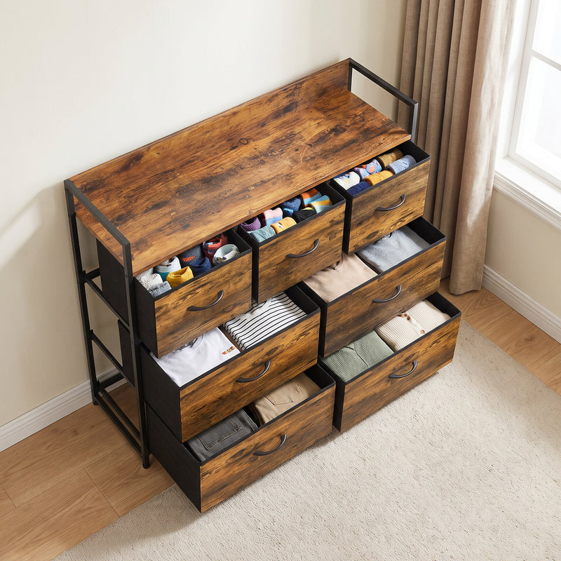Angled view of the chest of drawers with folded clothes and socks stored in the fabric drawers