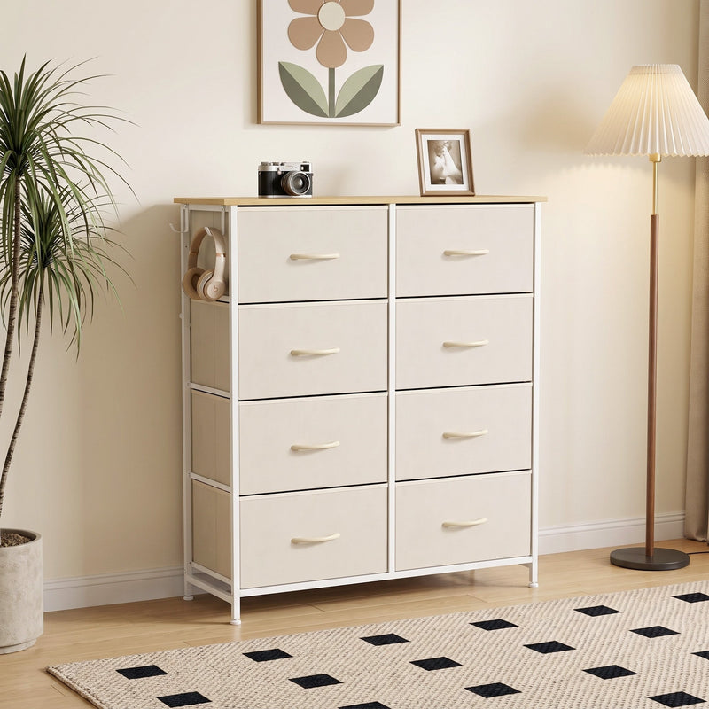 Beige chest of drawers styled in a living room corner beside a floor lamp and plant