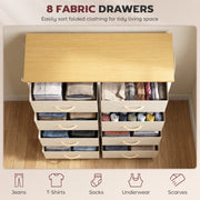 Eight open drawers holding folded clothes, viewed from above on a wooden floor