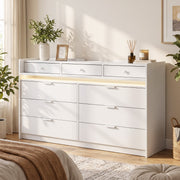 White chest of drawers with warm LED strip in a bright bedroom