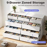White chest of drawers showing 3 small drawers and 6 large drawers filled with clothes