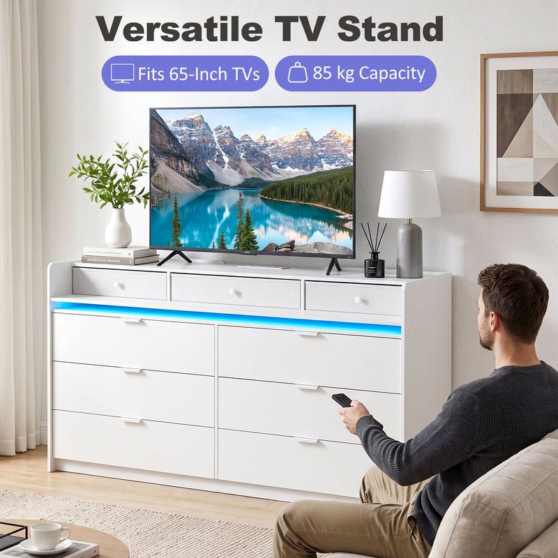 White chest of drawers used as a TV stand holding a 65 inch TV
